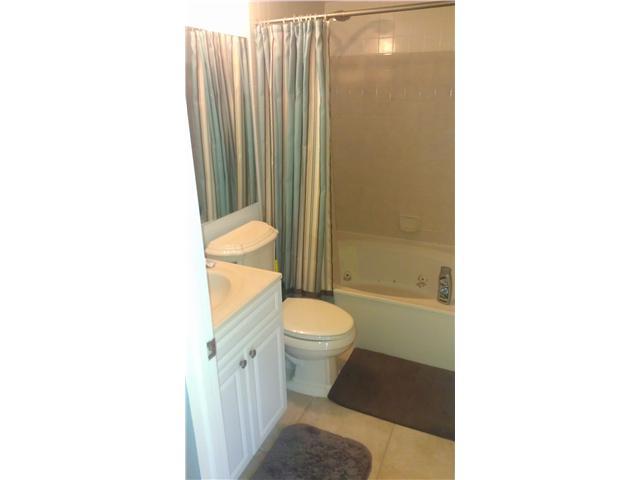8242 Severn Drive, Unit A Boca Raton, FL 33433 - Photo 6 of 11 a bathroom with a toilet and a shower