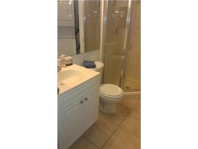 8242 Severn Drive, Unit A Boca Raton, FL 33433 - Photo 10 of 11 a bathroom with a sink a toilet and shower