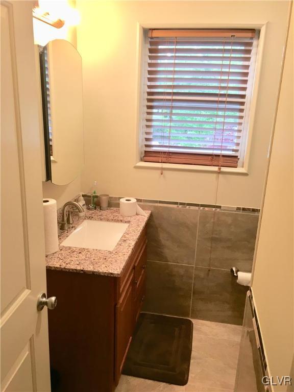 82 Waldheim Park Allentown, PA 18103 - Photo 16 of 22 a bathroom with a granite countertop sink and a mirror