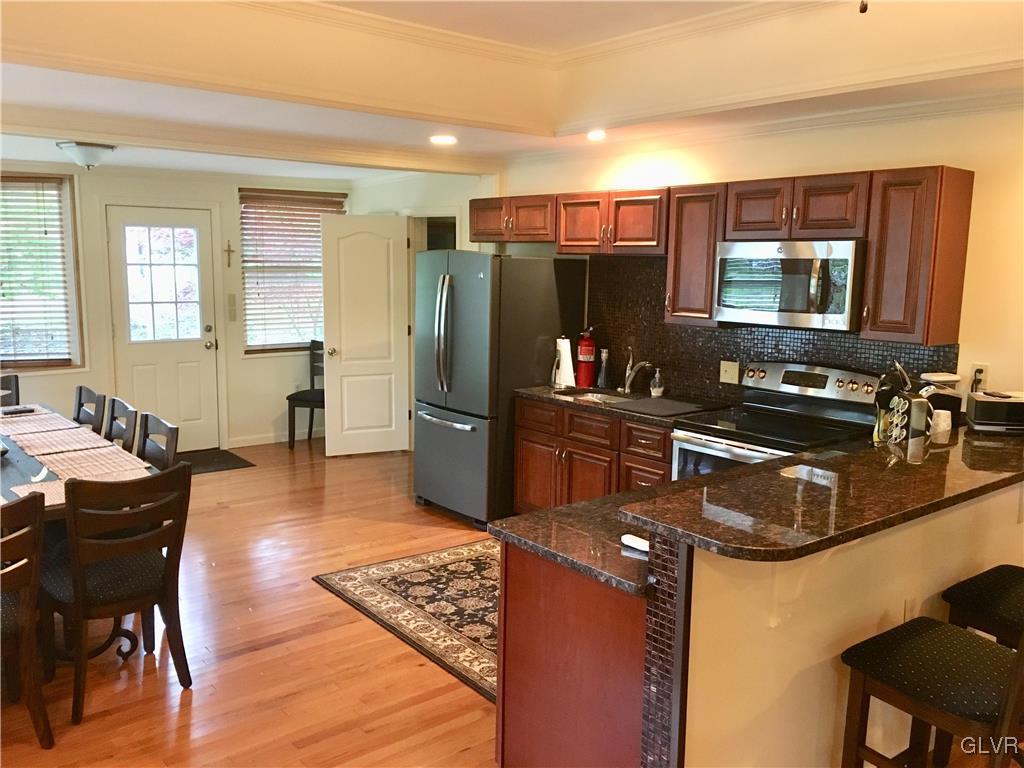 82 Waldheim Park Allentown, PA 18103 - Photo 4 of 22 a kitchen with stainless steel appliances granite countertop a sink dishwasher stove and refrigerator with wooden floor