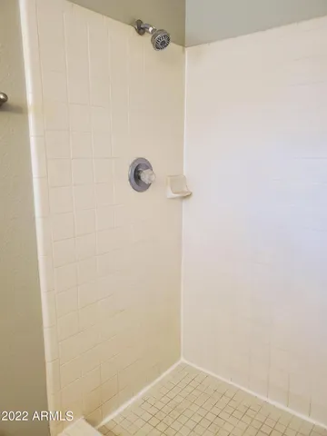 a view of a room with wooden floor and a window