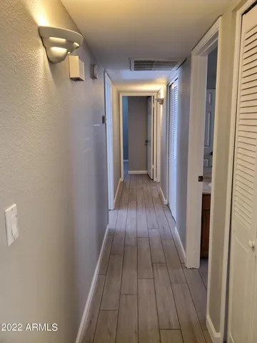 a view of a hallway with wooden floor