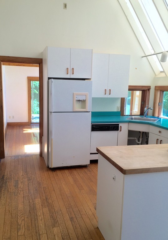 1470 Main Road Westport, MA 02790 - Photo 15 of 17 a kitchen with stainless steel appliances granite countertop a refrigerator a stove and a wooden floors