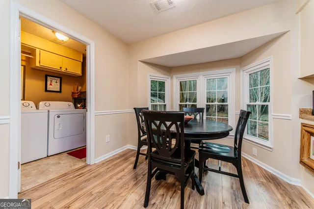 a view of a dining room with furniture and wooden floor