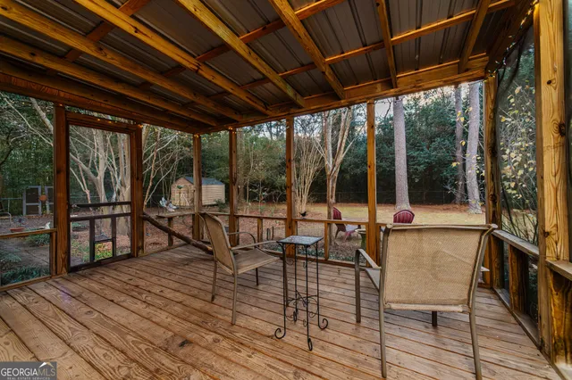 a view of balcony with chairs and wooden floor