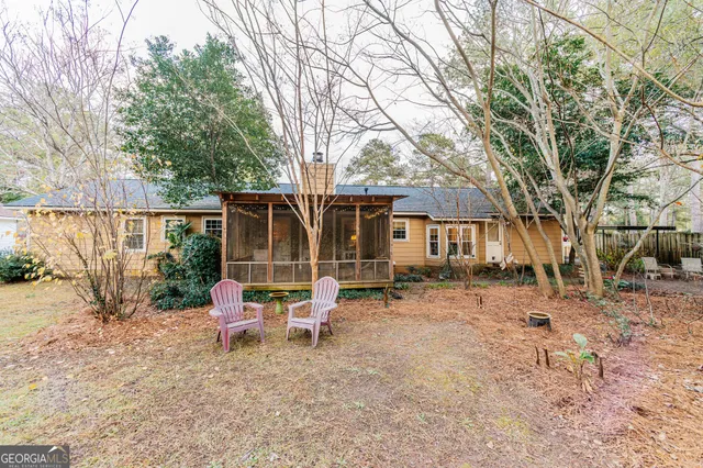 a backyard of a house with table and chairs