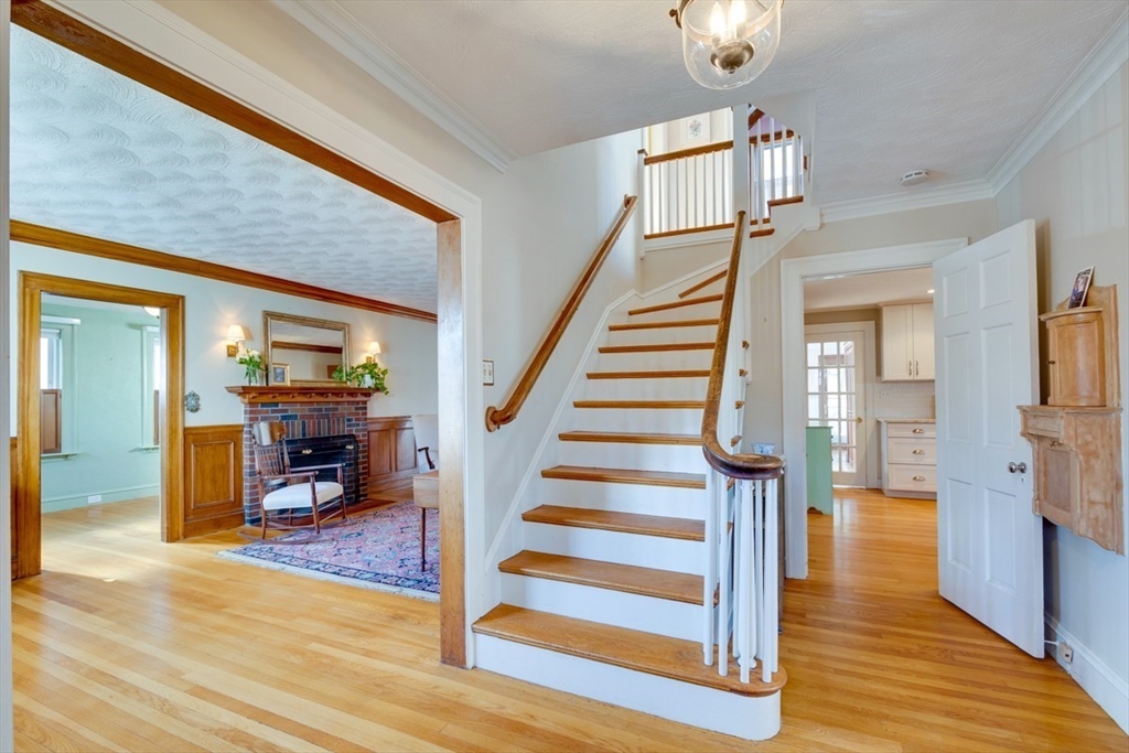 97 Standish Road Watertown, MA 02472 - Photo 3 of 30 a view of a livingroom kitchen and hall with wooden floor