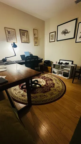 a living room with furniture and painting on the wall