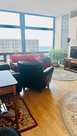 a living room with furniture and a large window