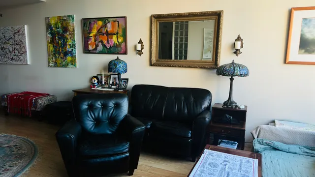 a living room with furniture and a potted plant