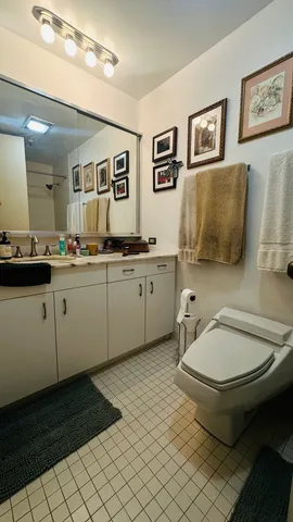 a spacious bathroom with a toilet a sink and mirror
