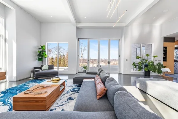 a living room with a bed furniture and a flat tv screen