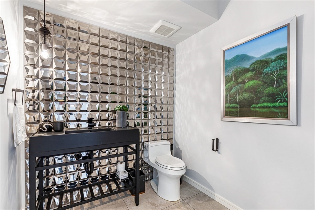 85 Forbes Road Milton, MA 02186 - Photo 16 of 39 a bathroom with a sink a toilet and a shower curtain