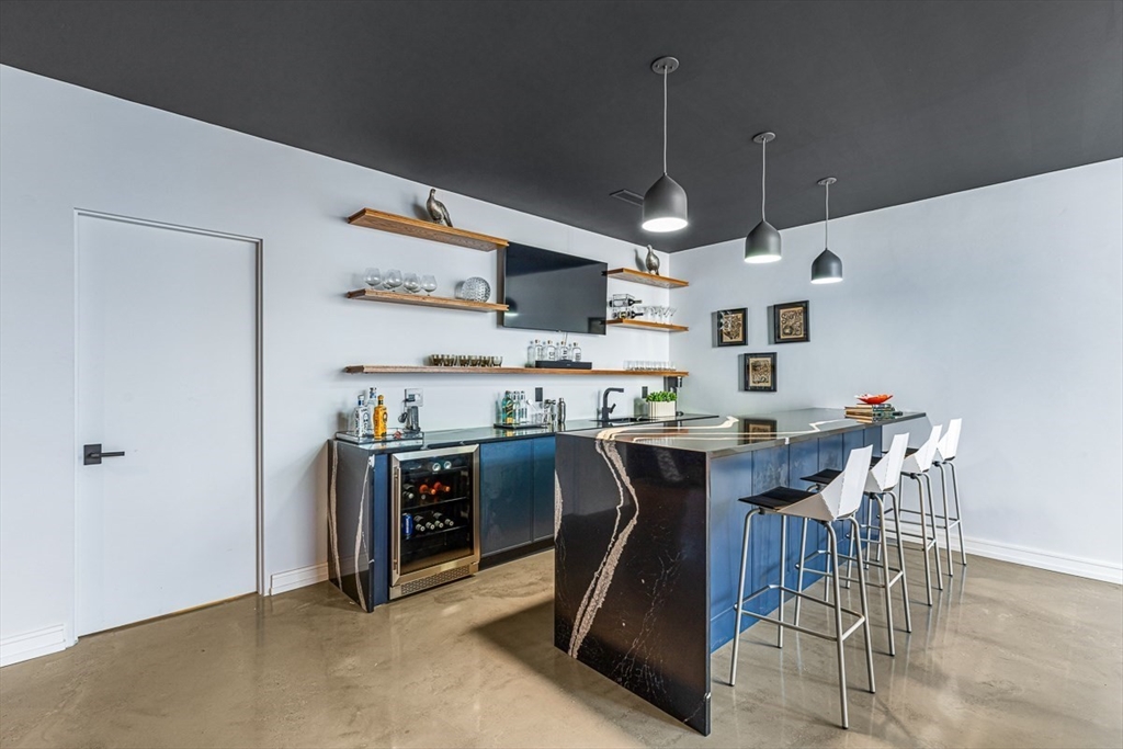 85 Forbes Road Milton, MA 02186 - Photo 20 of 39 a kitchen with kitchen island stainless steel appliances a table and chairs in it