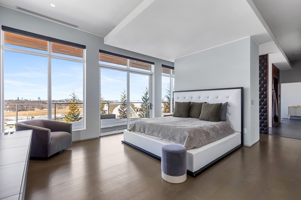 85 Forbes Road Milton, MA 02186 - Photo 33 of 39 a spacious bedroom with a large bed and a large window