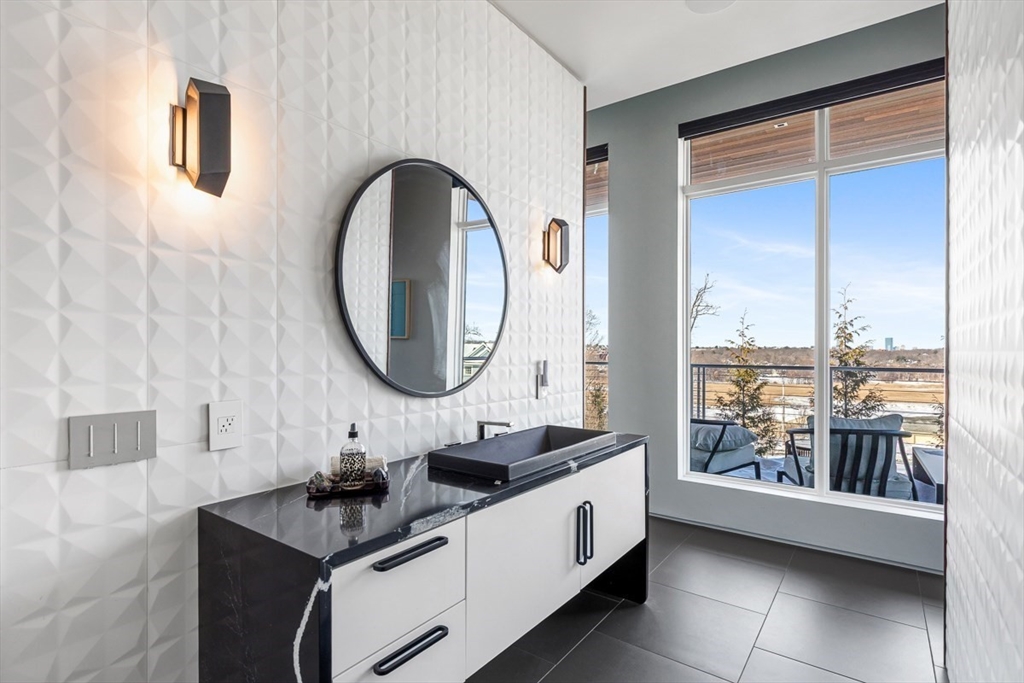 85 Forbes Road Milton, MA 02186 - Photo 34 of 39 a bathroom with a double vanity sink and a mirror