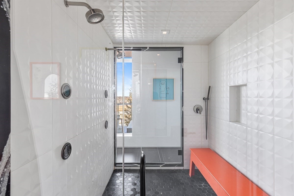 85 Forbes Road Milton, MA 02186 - Photo 35 of 39 a bathroom with a tub shower sink and mirror