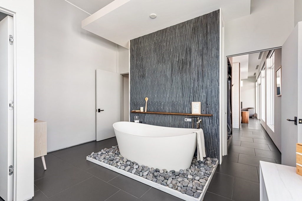 85 Forbes Road Milton, MA 02186 - Photo 38 of 39 a bathroom with a bathtub and shower