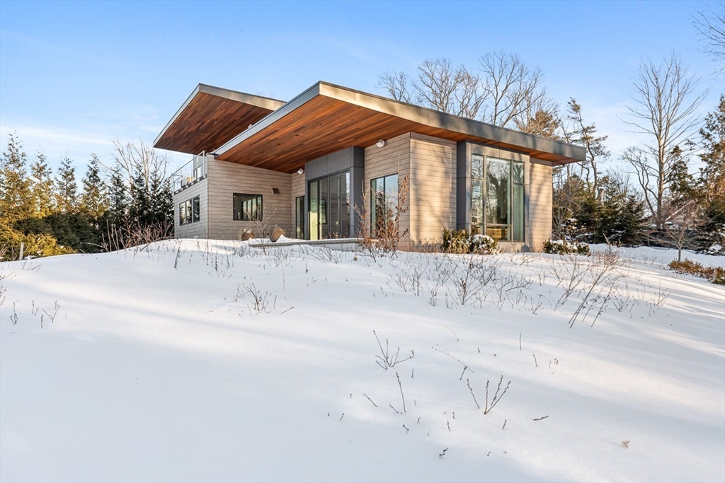 85 Forbes Road Milton, MA 02186 - Photo 39 of 39 a patio with a table and chairs and a barbeque