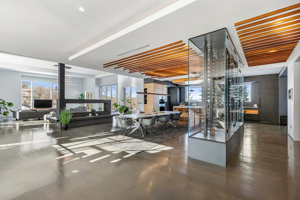 85 Forbes Road Milton, MA 02186 - Photo 4 of 39 a living room with furniture and a dining table with kitchen view