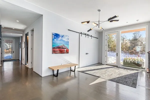 a living room with furniture and a dining table with kitchen view