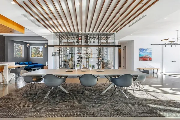 a view of a dining room with furniture wooden floor and a chandelier