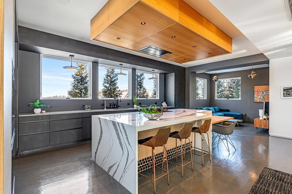 85 Forbes Road Milton, MA 02186 - Photo 10 of 39 a view of a dining room with furniture wooden floor and a chandelier
