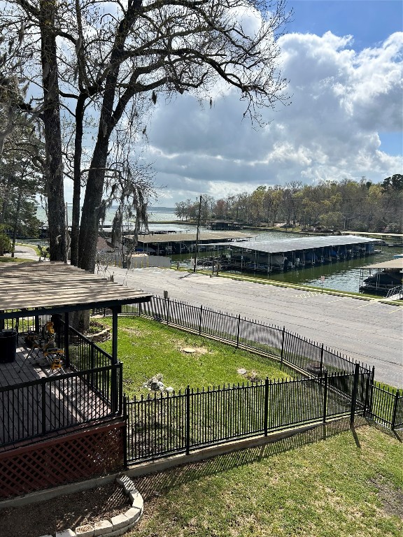 30 Harbour Lane Coldspring, TX 77331 - Photo 28 of 31 a view of a lake with wooden fence