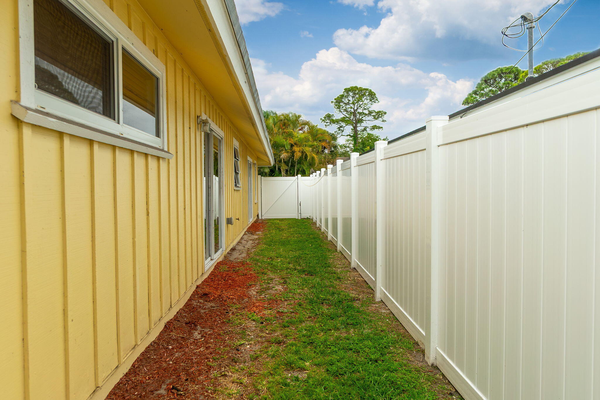 6130 Francis Street Jupiter, FL 33458 - Photo 18 of 27 a view of a pathway of a house with a yard