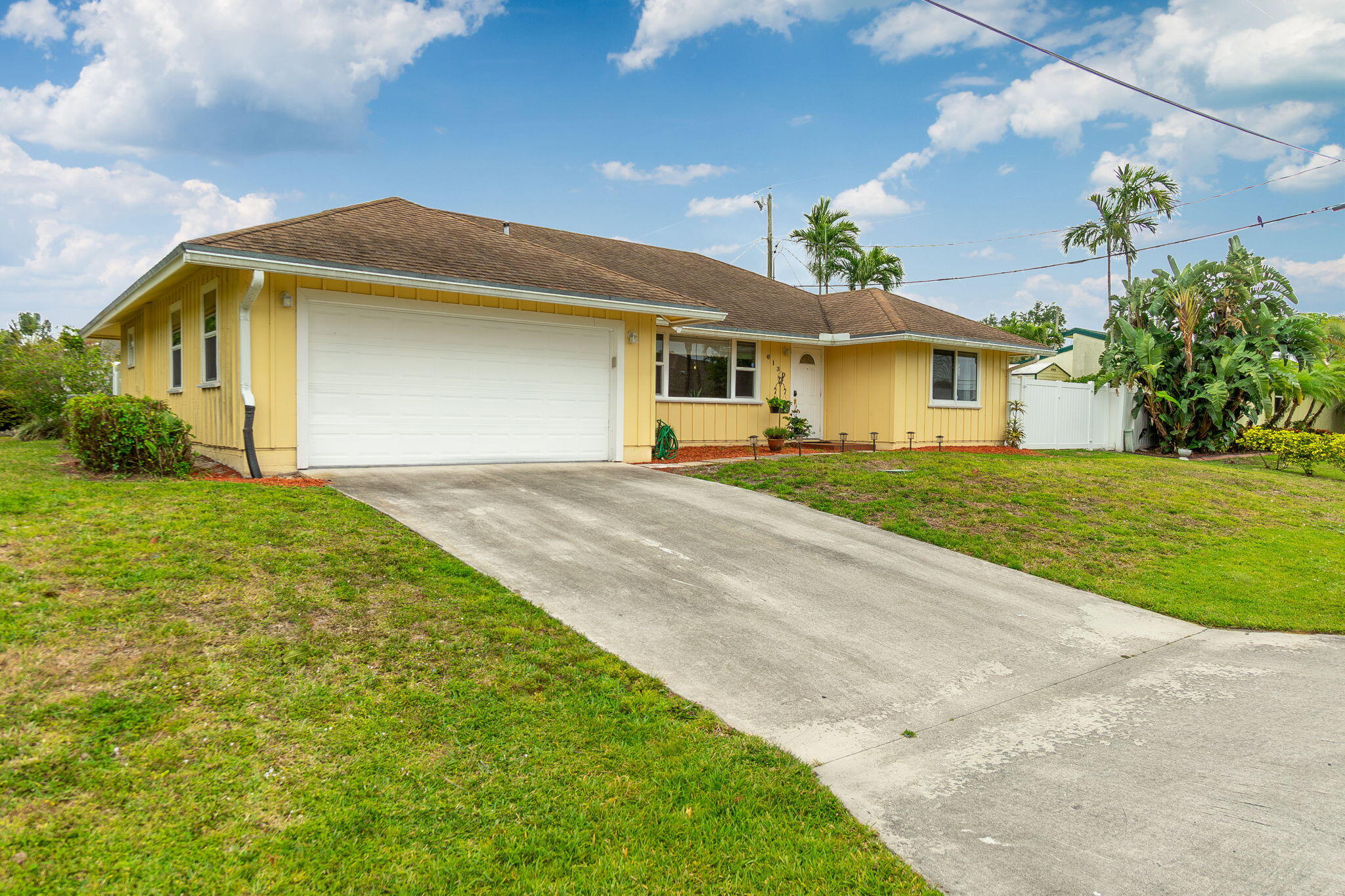 6130 Francis Street Jupiter, FL 33458 - Photo 2 of 27 a front view of a house with a yard