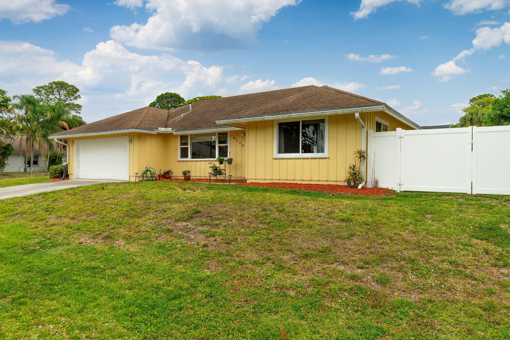 6130 Francis Street Jupiter, FL 33458 - Photo 3 of 27 a front view of house with yard and green space