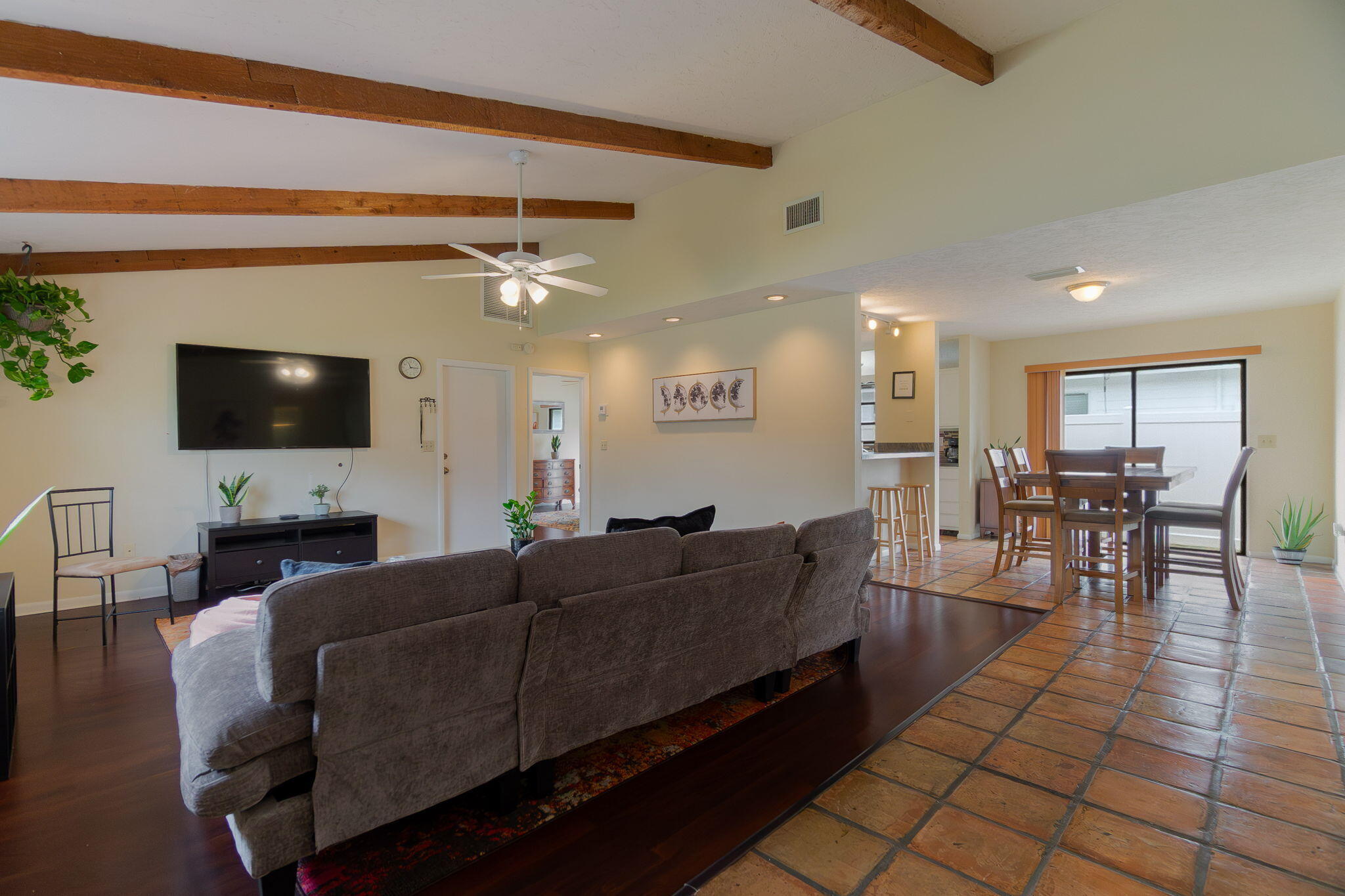 6130 Francis Street Jupiter, FL 33458 - Photo 5 of 27 a living room with furniture a flat screen tv and kitchen view