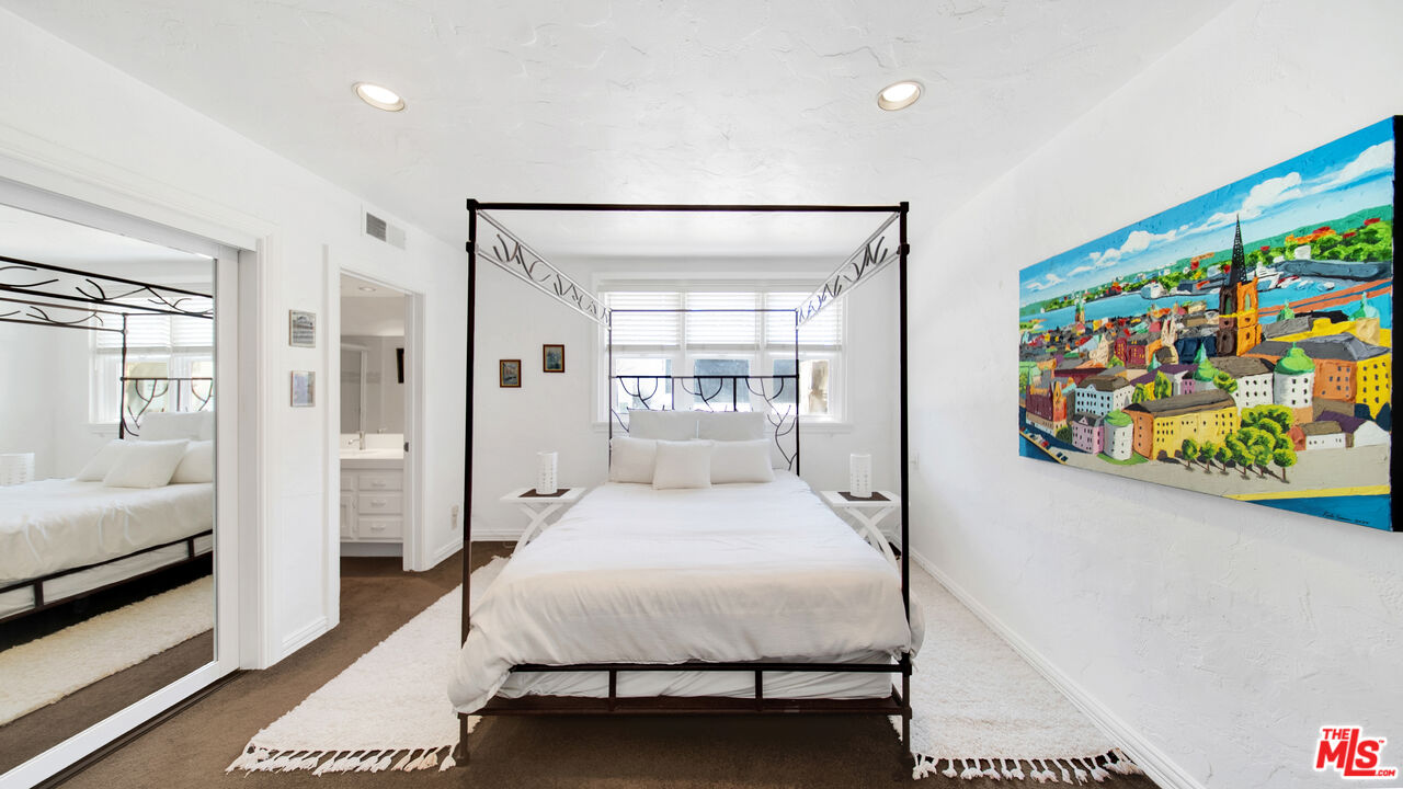 2312 Kimridge Road Beverly Hills, CA 90210 - Photo 34 of 60 a bedroom with a bed painting on wall and a potted plant