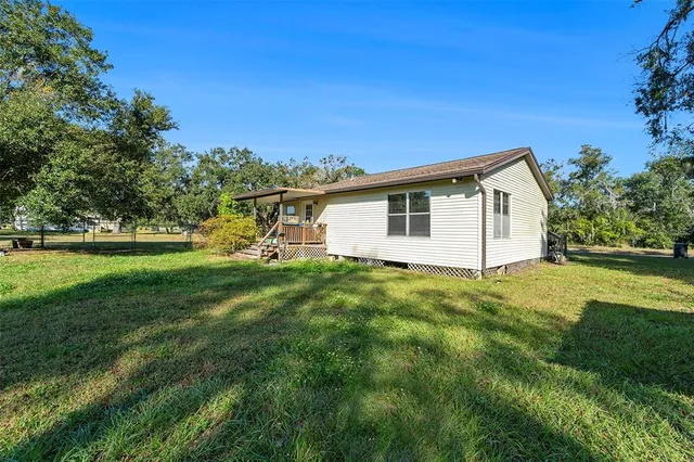 a view of an house with backyard space and garden