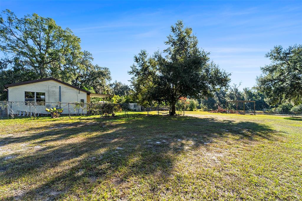 2215 Wallace Road Lutz, FL 33549 - Photo 4 of 15 a view of a house with a yard