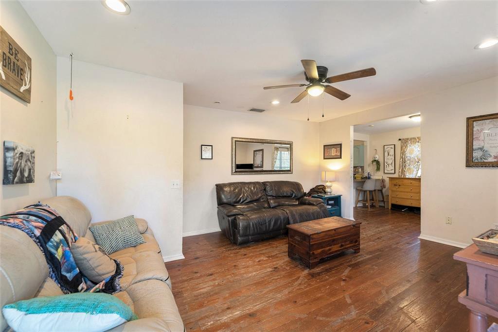 2215 Wallace Road Lutz, FL 33549 - Photo 7 of 15 a living room with furniture ceiling fan and a rug