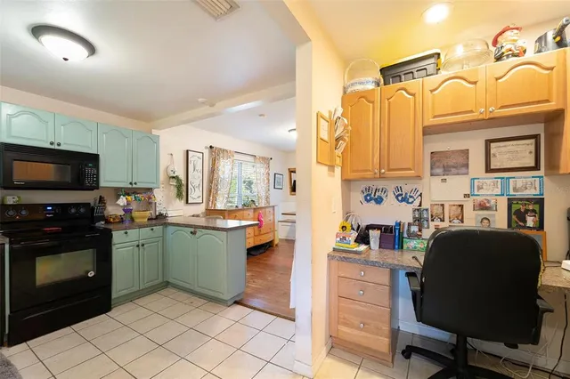 a kitchen with a sink refrigerator and cabinets