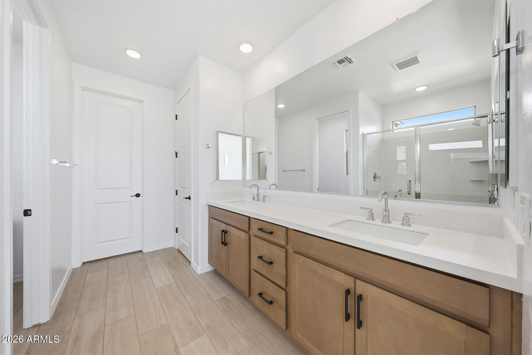 705 West Riparian Drive San Tan Valley, AZ 85140 - Photo 11 of 25 a spacious bathroom with a double vanity sink a mirror and a shower