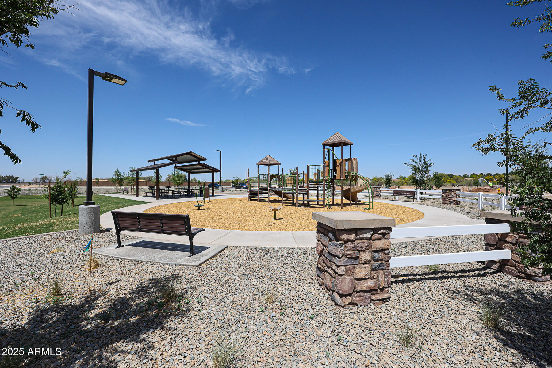 705 West Riparian Drive San Tan Valley, AZ 85140 - Photo 20 of 25 a park view with a bench and trees in the background
