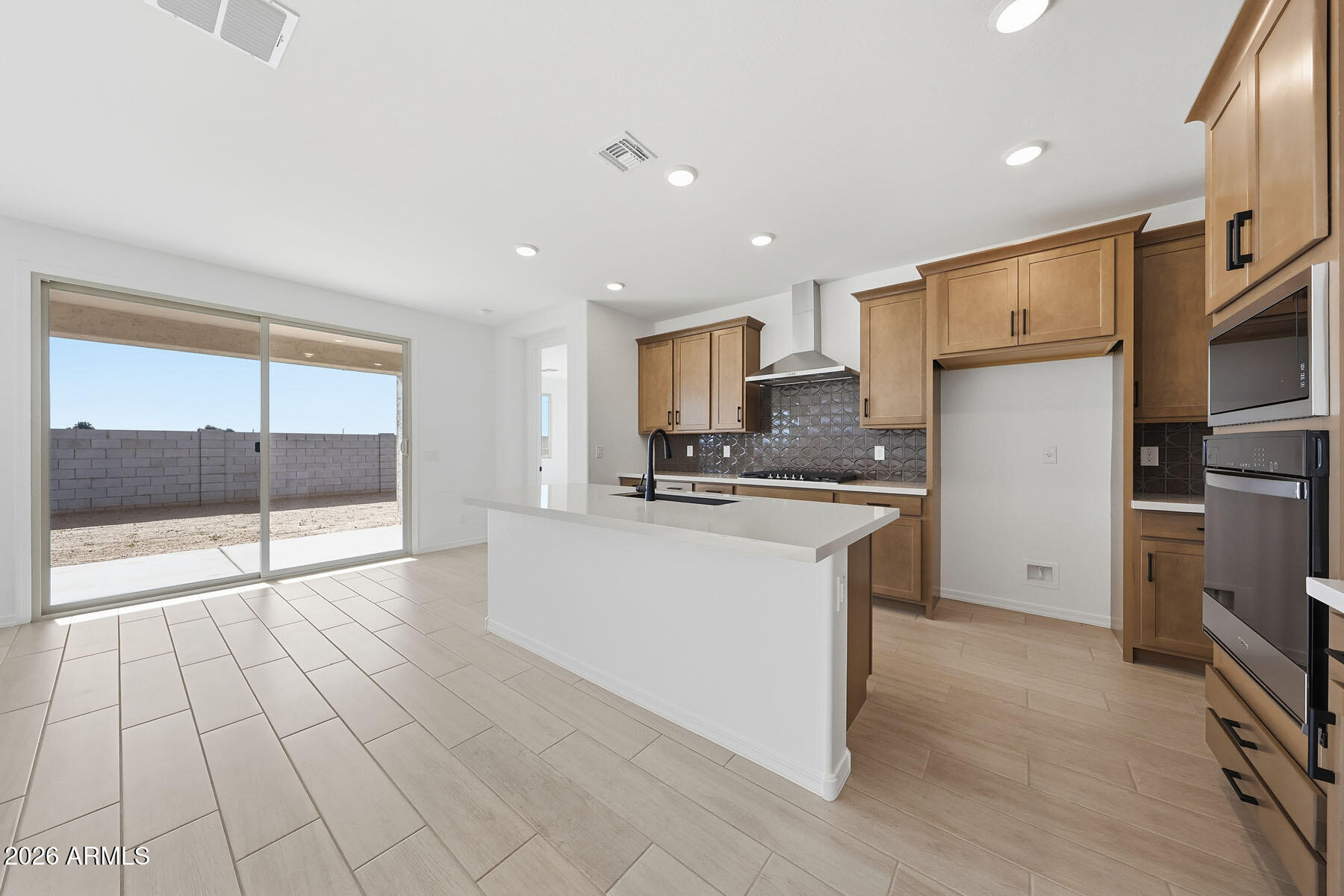705 West Riparian Drive San Tan Valley, AZ 85140 - Photo 5 of 25 a kitchen with stainless steel appliances a refrigerator and a stove top oven