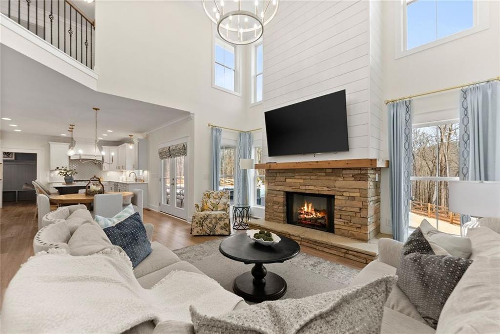 6998 Britt Gailey Road Clermont, GA 30527 - Photo 17 of 92 a living room with furniture a fireplace and a flat screen tv