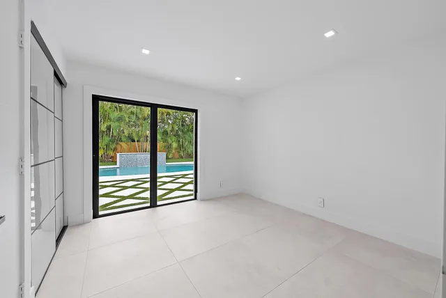 a bedroom with a large bed and a potted plant