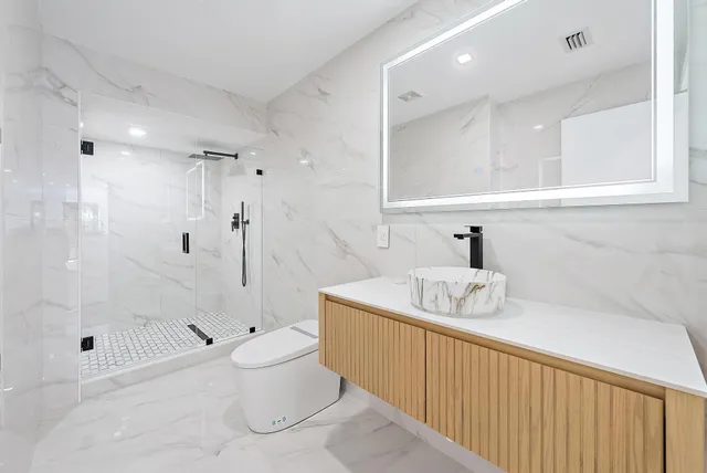 a spacious bathroom with a shower and a sink