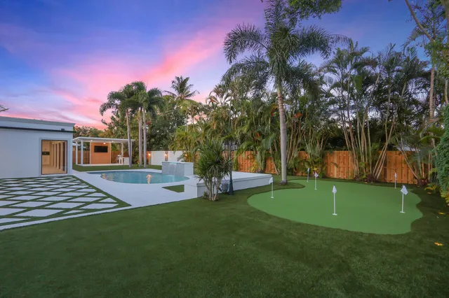 an aerial view of a house with a yard and garden