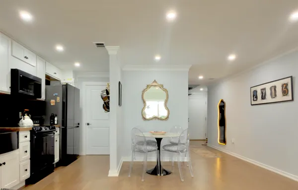 a view of a hallway with furniture and a window