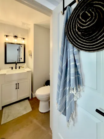 a bathroom with a sink a toilet and a mirror