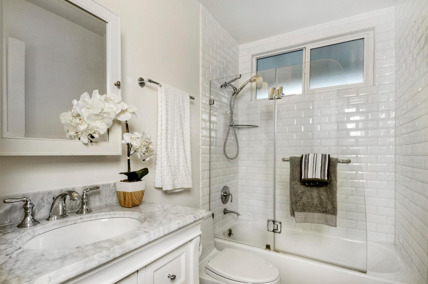 4106 George Avenue, Unit 2 San Mateo, CA 94403 - Photo 12 of 20 a bathroom with a granite countertop sink a toilet and shower