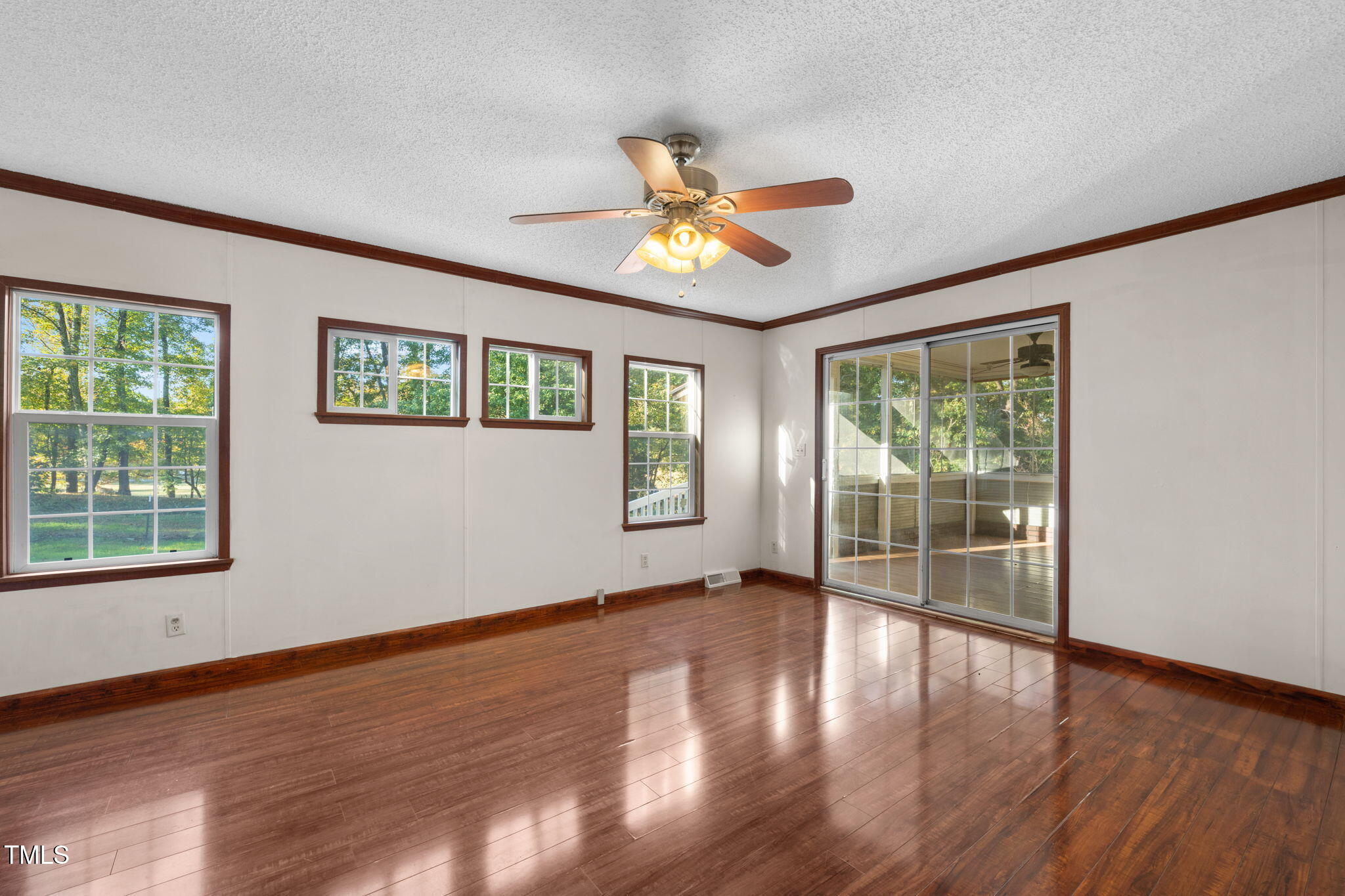 538 Allie Clay Road Roxboro, NC 27573 - Photo 12 of 37 a view of an empty room with wooden floor and a window