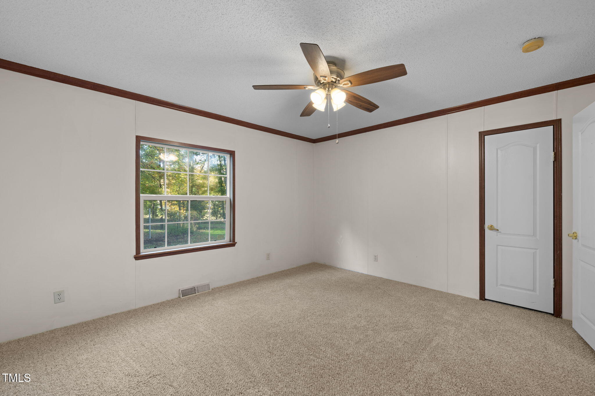 538 Allie Clay Road Roxboro, NC 27573 - Photo 23 of 37 an empty room with a window and a fan