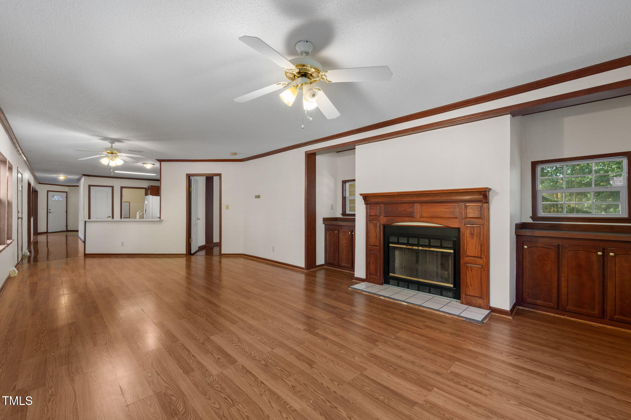 538 Allie Clay Road Roxboro, NC 27573 - Photo 5 of 37 a view of an empty room with wooden floor fireplace and a window